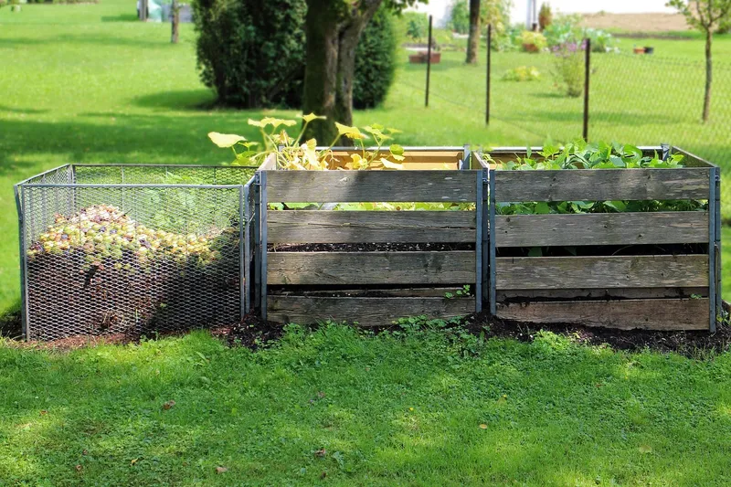 Dark, rich organic compost being mixed into garden soil
